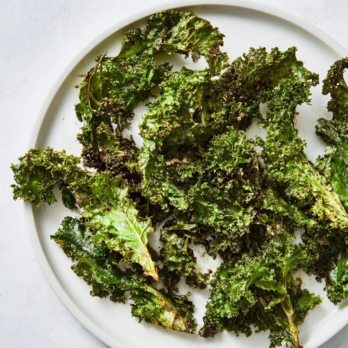 Golden-brown, perfectly crispy oven-baked kale chips, a healthy and satisfying snack bursting with flavor.