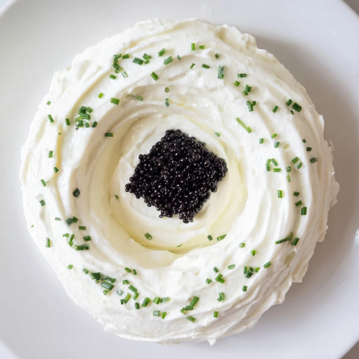 Visually stunning Diamond Inlay appetizer of caviar, ringed by creamy cream cheese, ready to delight guests.