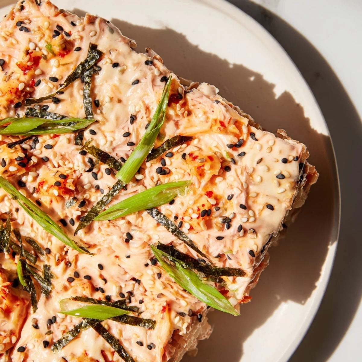 Creamy Salmon Sushi Bake: A golden and bubbly casserole showcasing tender salmon with a delightful cheesy top.