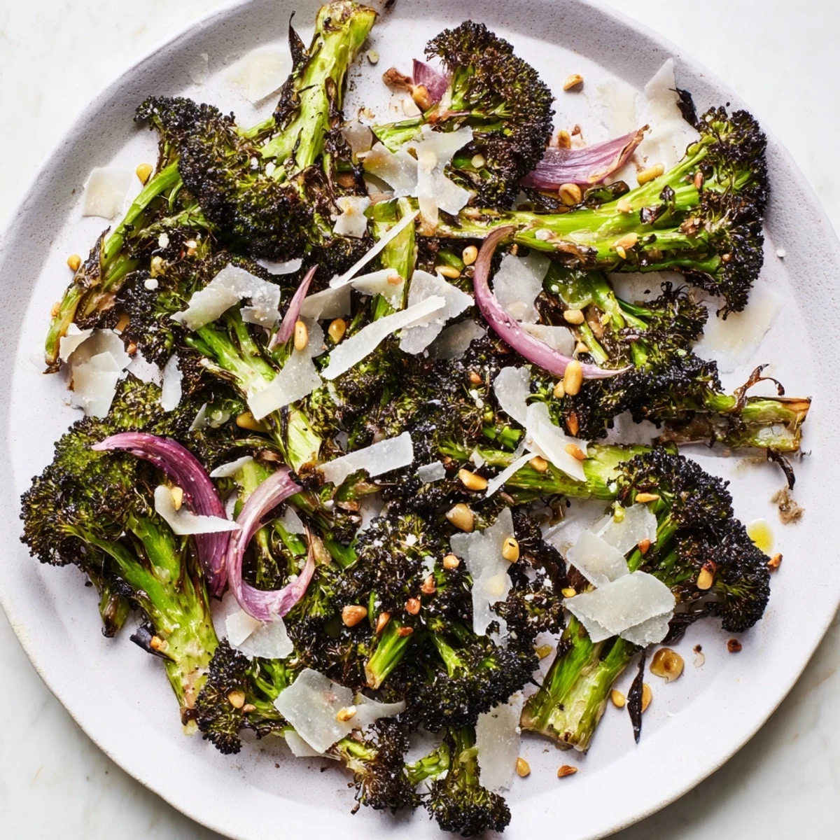 Freshly made charred broccoli salad is plated beautifully, a vibrant vegetarian option for a light meal.