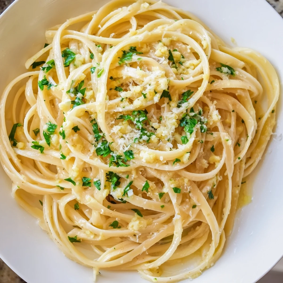 Steaming plate of comforting Garlic Butter Linguine, tossed with garlic and herbs, a quick and easy recipe.