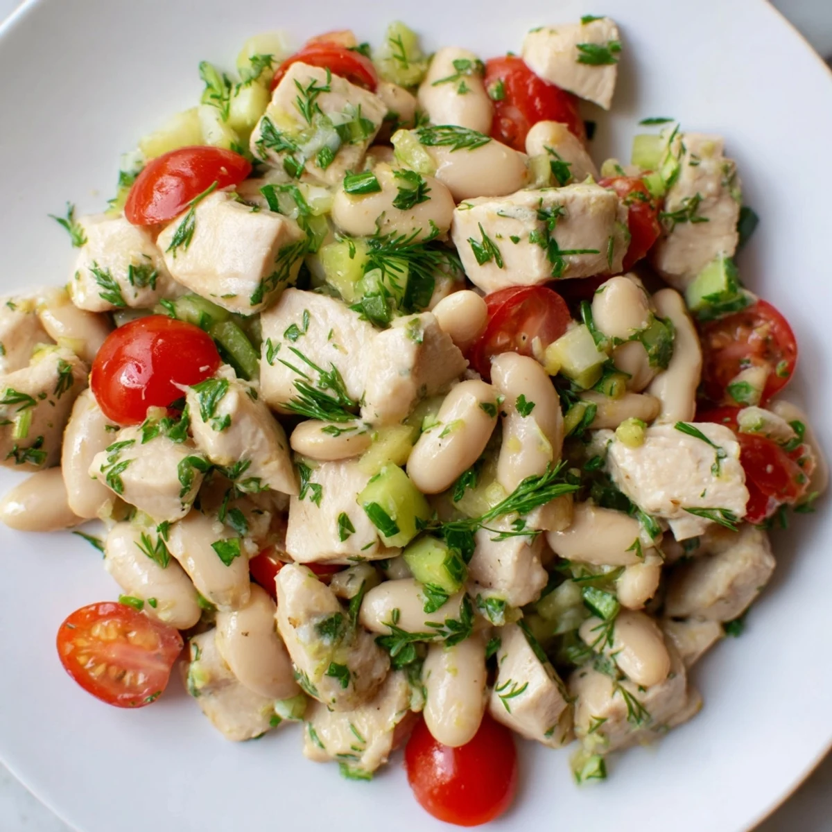 Bright and tangy Lemony White Bean Chicken Salad with shredded chicken, creamy white beans, crisp celery, and fresh herbs tossed in a zesty lemon vinaigrette.