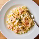 Flaky hot-smoked salmon folded into silky Creamy Salmon Pasta, served steaming on a plate with crusty bread.