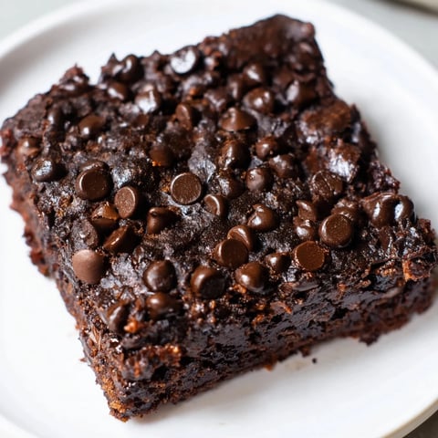 Fudgy Greek Yogurt Brownies, a delightful, dark chocolate dessert with a light, creamy texture.
