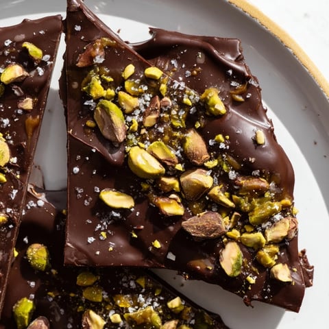 Creamy caramel and dark chocolate Pistachio Salted Caramel Bark topped with bright green pistachios.