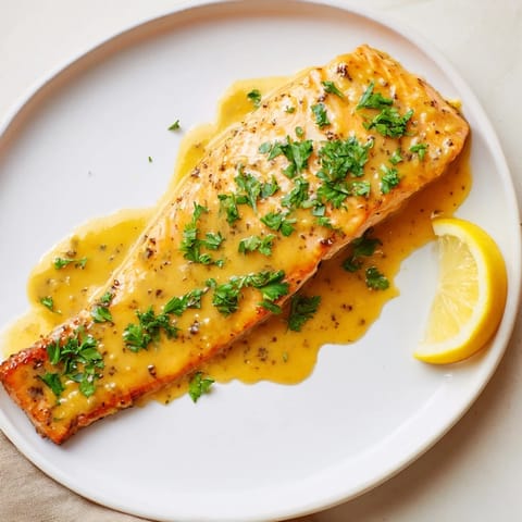 Perfectly broiled honey mustard glazed salmon, served with fresh parsley and bright lemon wedges.