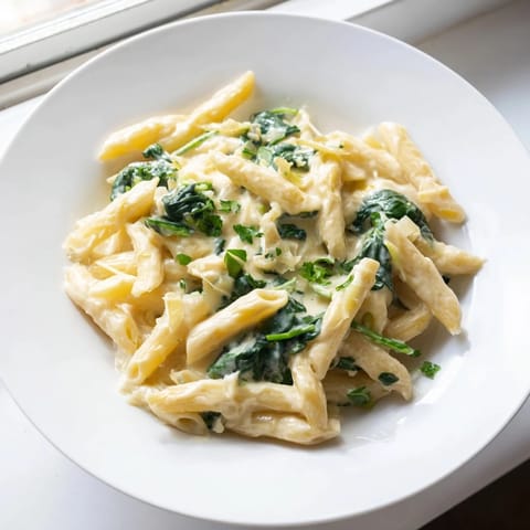 Golden, creamy The Magic Casserole: Creamy Spinach Pasta with wilted spinach, ready to serve.