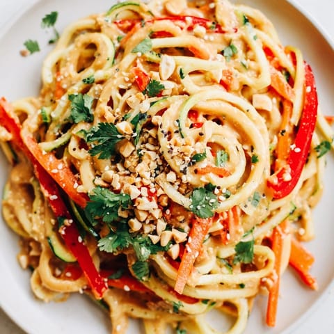 Cool, refreshing Zesty Peanut Zucchini Noodles: spiralized zucchini with a flavorful peanut dressing.