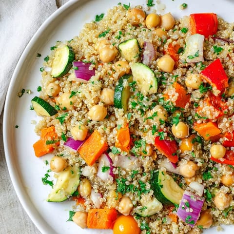 This vibrant quinoa power salad features colorful roasted veggies and a zesty tahini-lemon dressing.