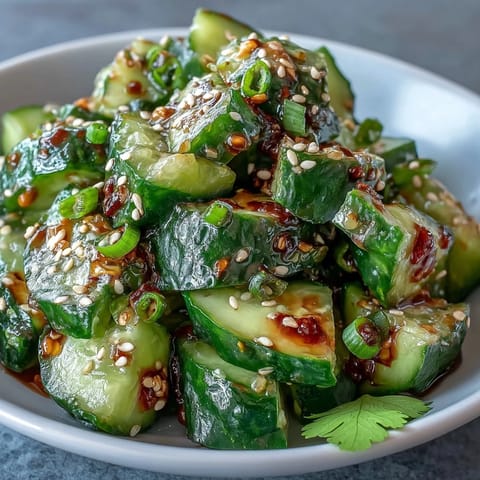 Crisp, smashed cucumber salad glistening with chili oil, perfect as a side.