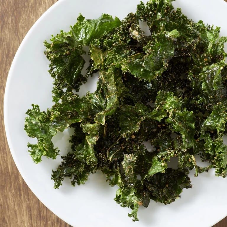 Close-up of freshly baked kale chips in the oven; these crispy delights offer a satisfying crunch.