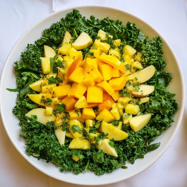 Enjoy a refreshing The Sunlit Glade salad, showcasing bright mango and pineapple with a lush green border.