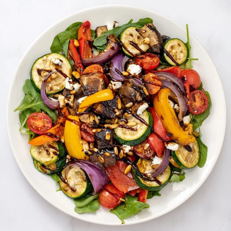 Warm, inviting, a delicious Roasted Vegetable Salad, the roasted veggies sit atop fresh greens ready to eat.