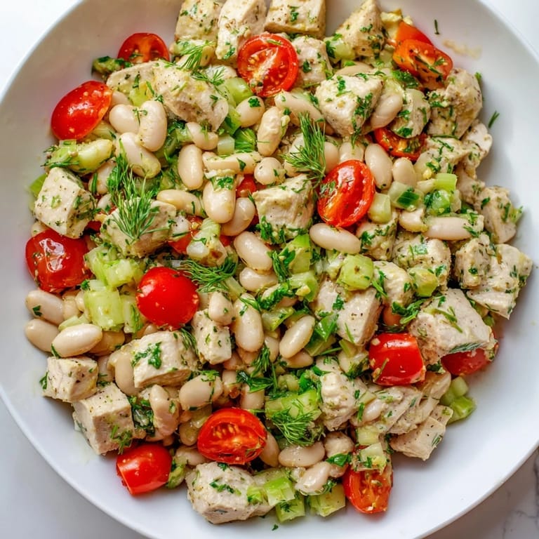 Healthy Lemony White Bean Chicken Salad served chilled on a plate, highlighting protein-packed chicken, crisp vegetables, and a glossy lemon herb dressing.