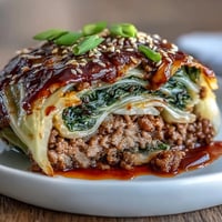 Steamed Korean Cabbage Rolls filled with savory spiced beef, ready for dipping.